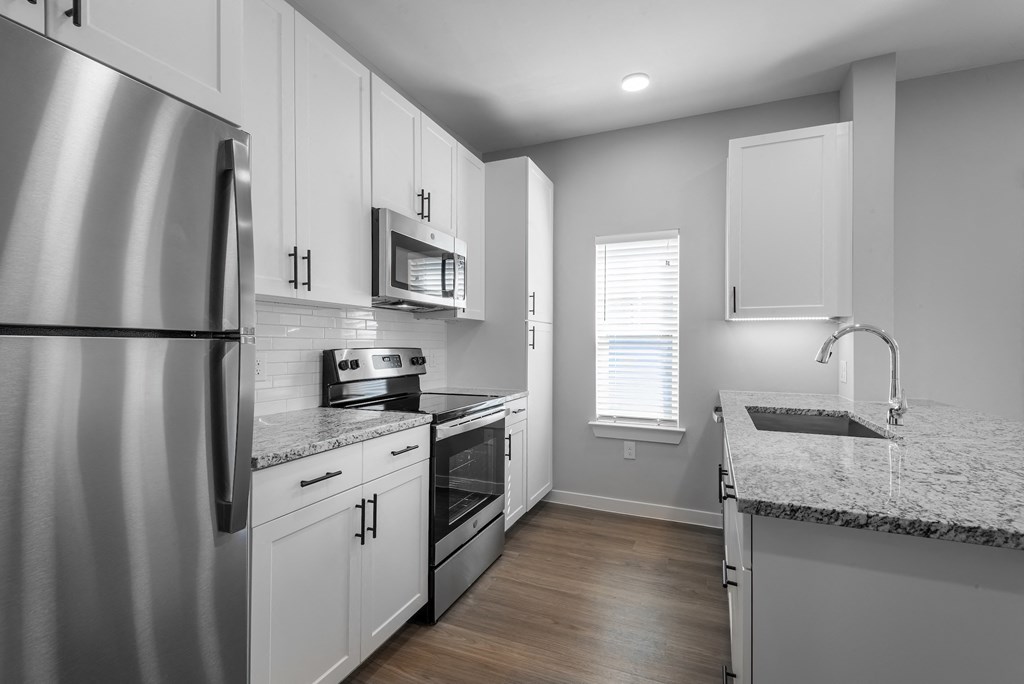a kitchen with stainless steel appliances and granite counter tops