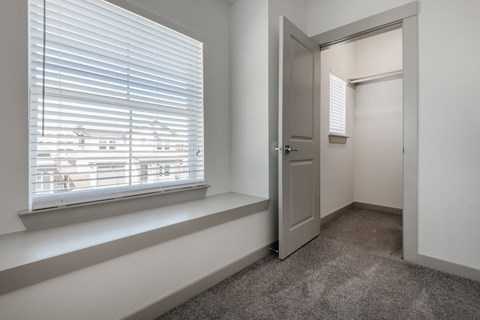 an empty room with a window and a door