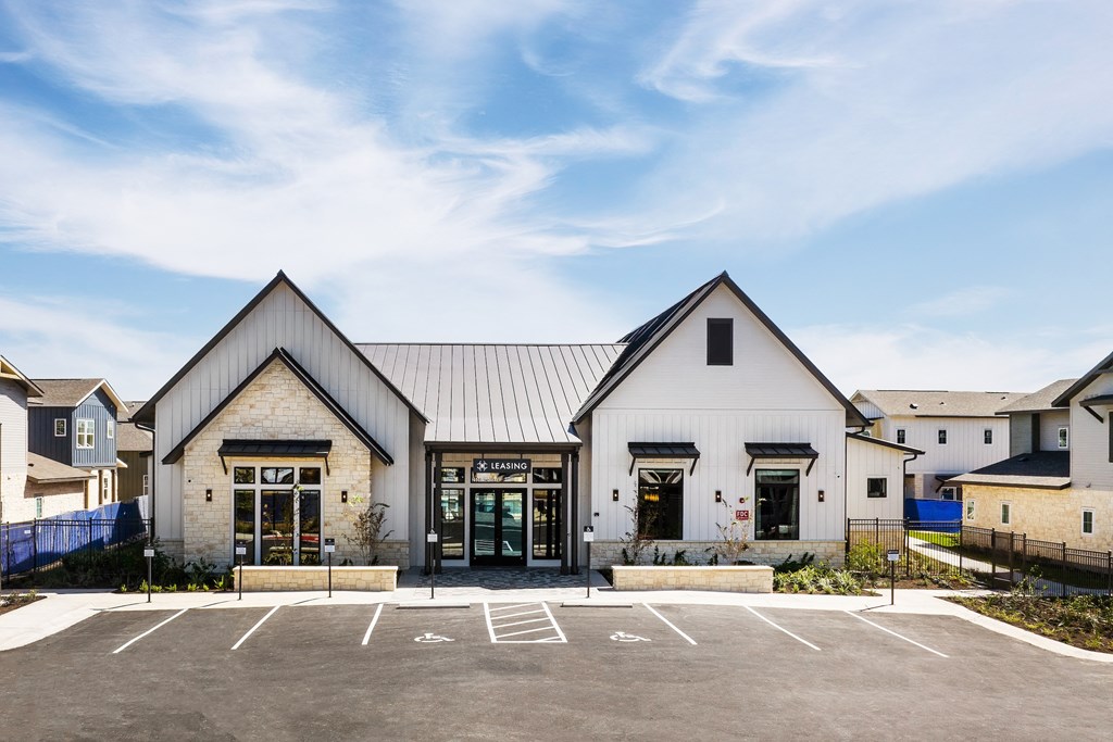 the exterior of a church with a parking lot