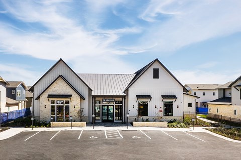 the exterior of a church with a parking lot