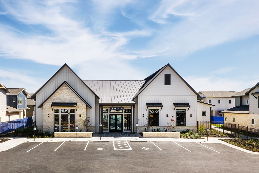 the exterior of a church with a parking lot