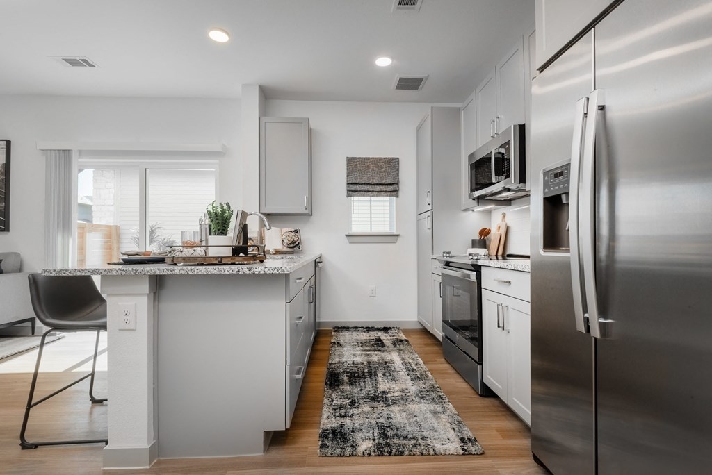 a kitchen with stainless steel appliances and a counter top