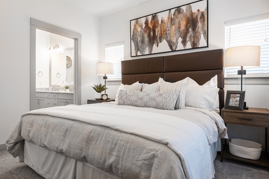 a bedroom with a bed and a dresser and a mirror