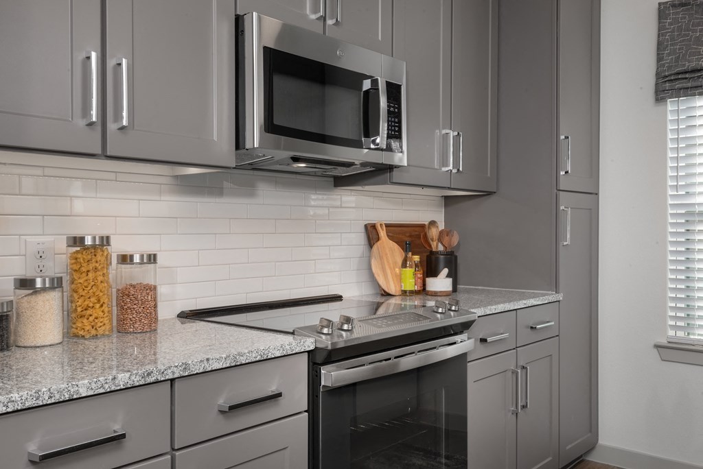 a modern kitchen with stainless steel appliances and granite counter tops