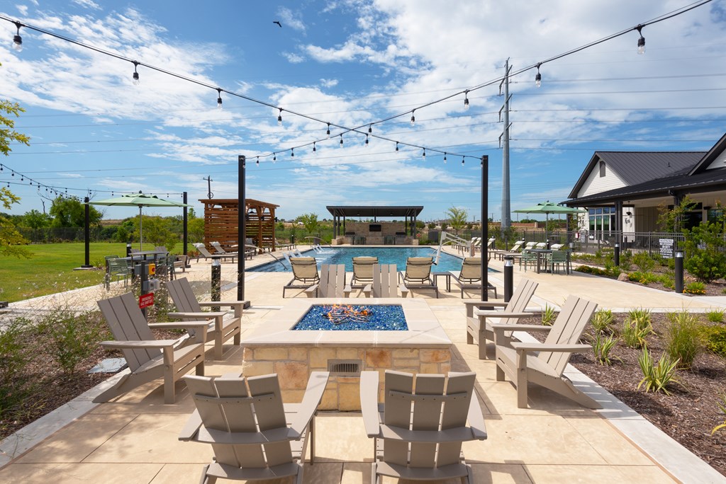 A pool area with chairs and a pool table.