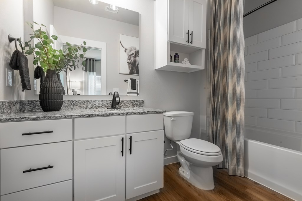 A bathroom with a white toilet and a white sink.
