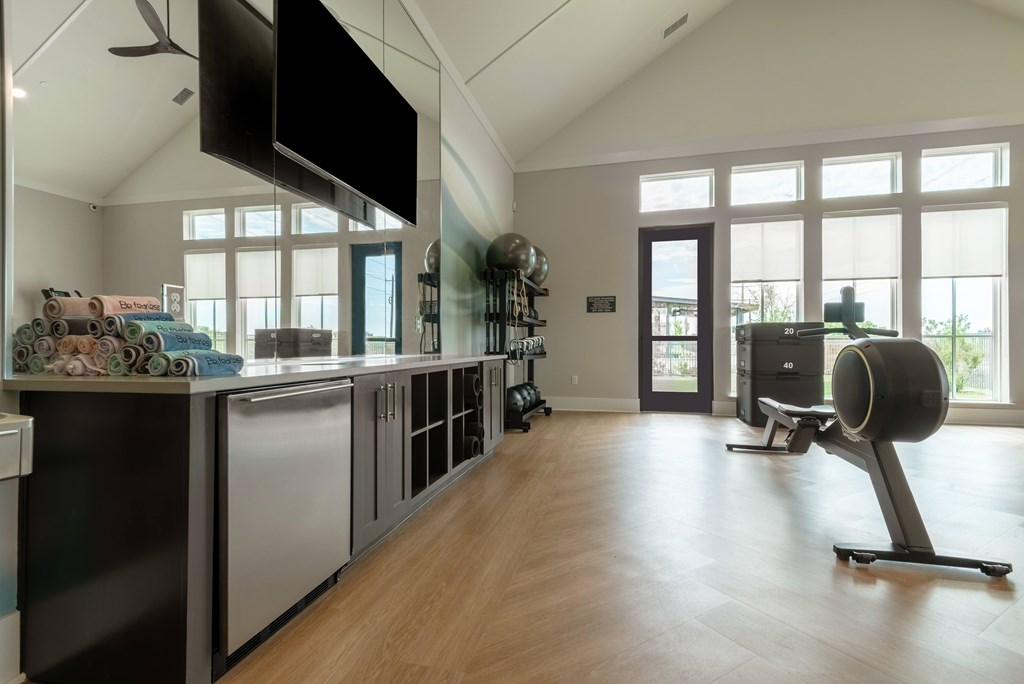 A modern kitchen with a large island and stainless steel appliances.