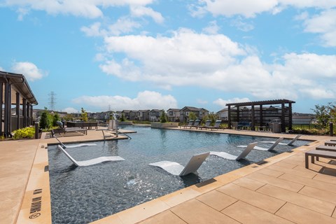 A large outdoor pool with a waterfall feature.