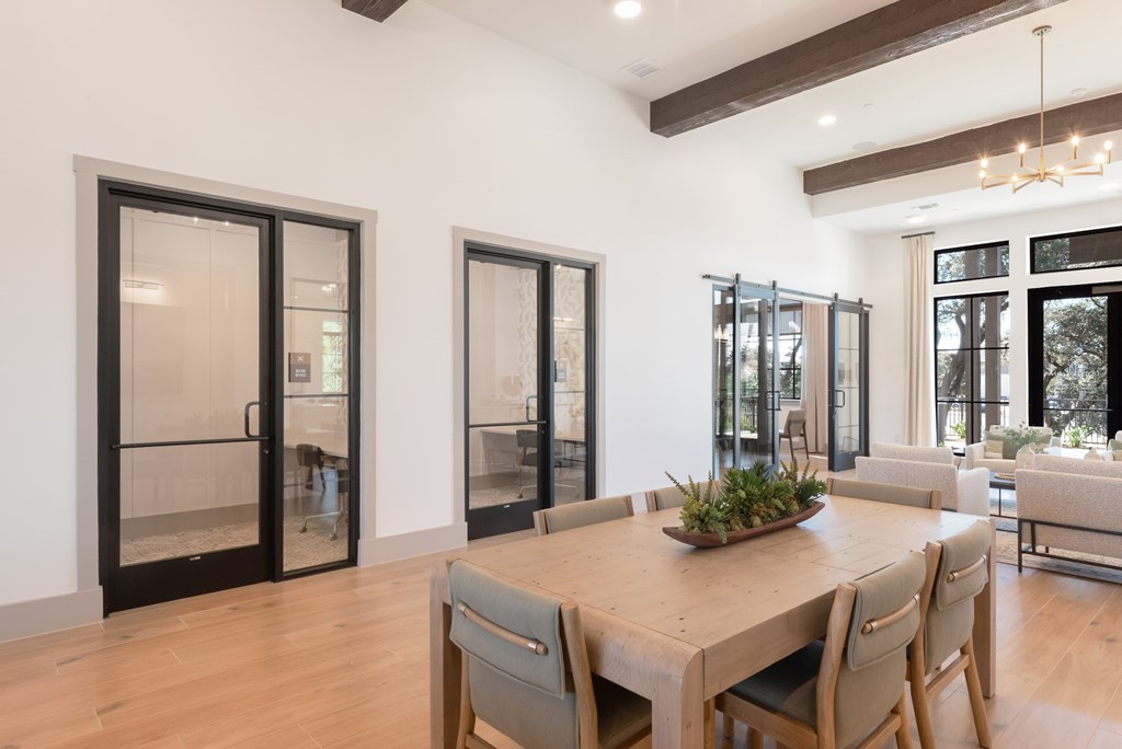 A dining room with a wooden table and chairs.