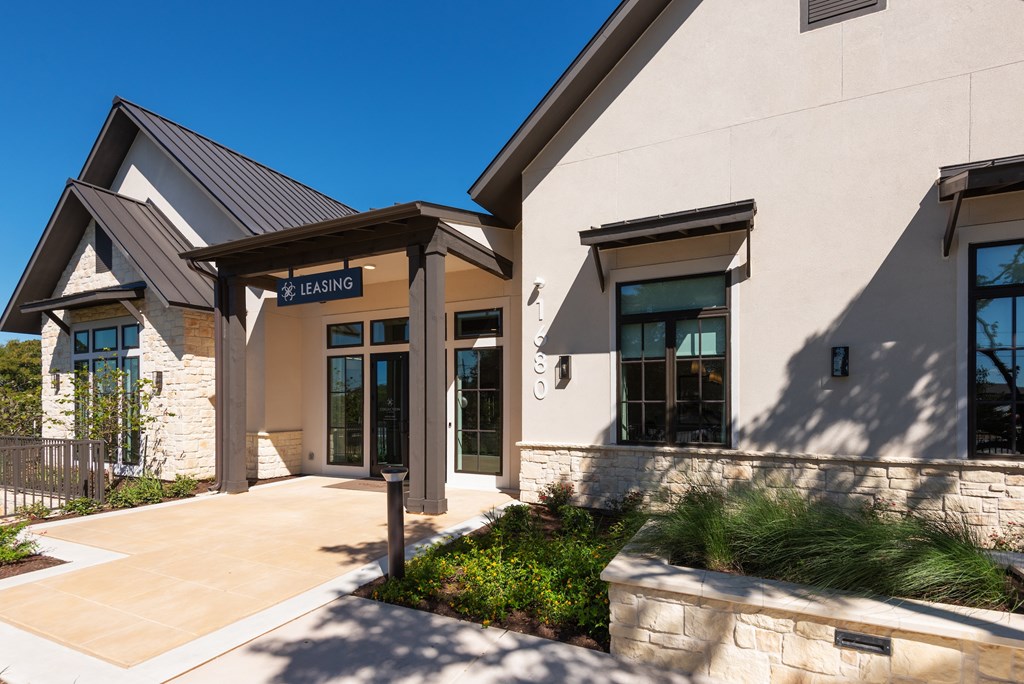 A modern building with a stone facade and a glass door.