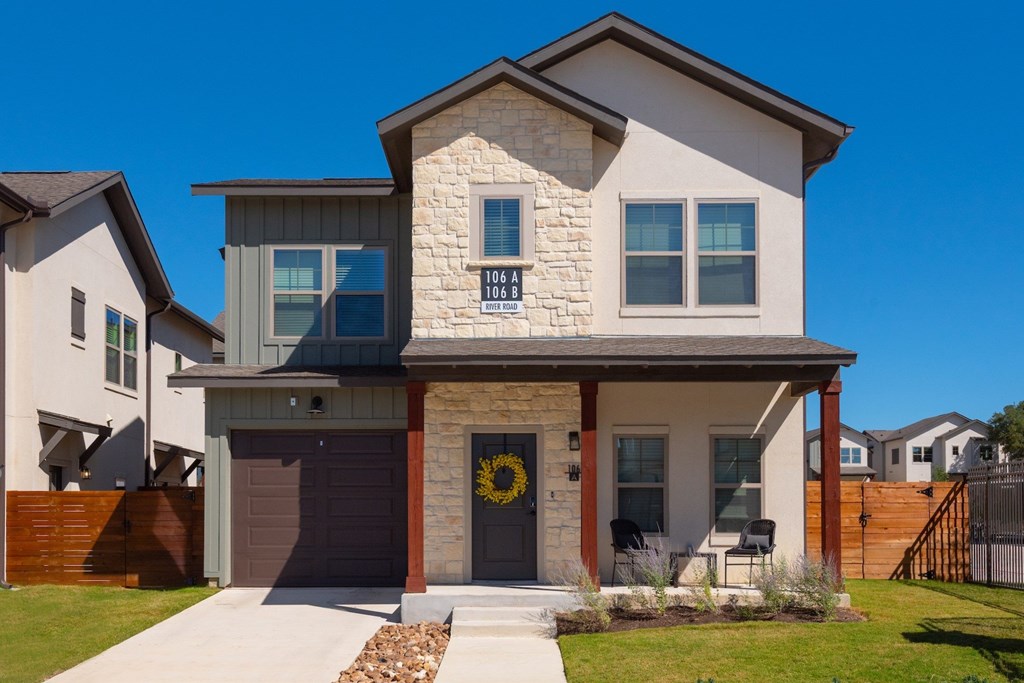 A modern house with a stone facade and a garage door.