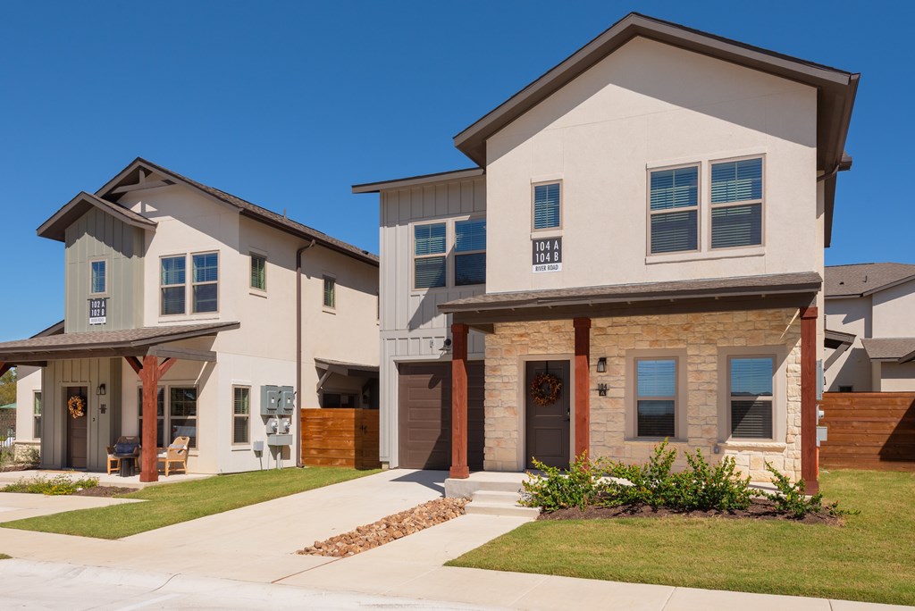 A modern two-story house with a garage and a driveway.