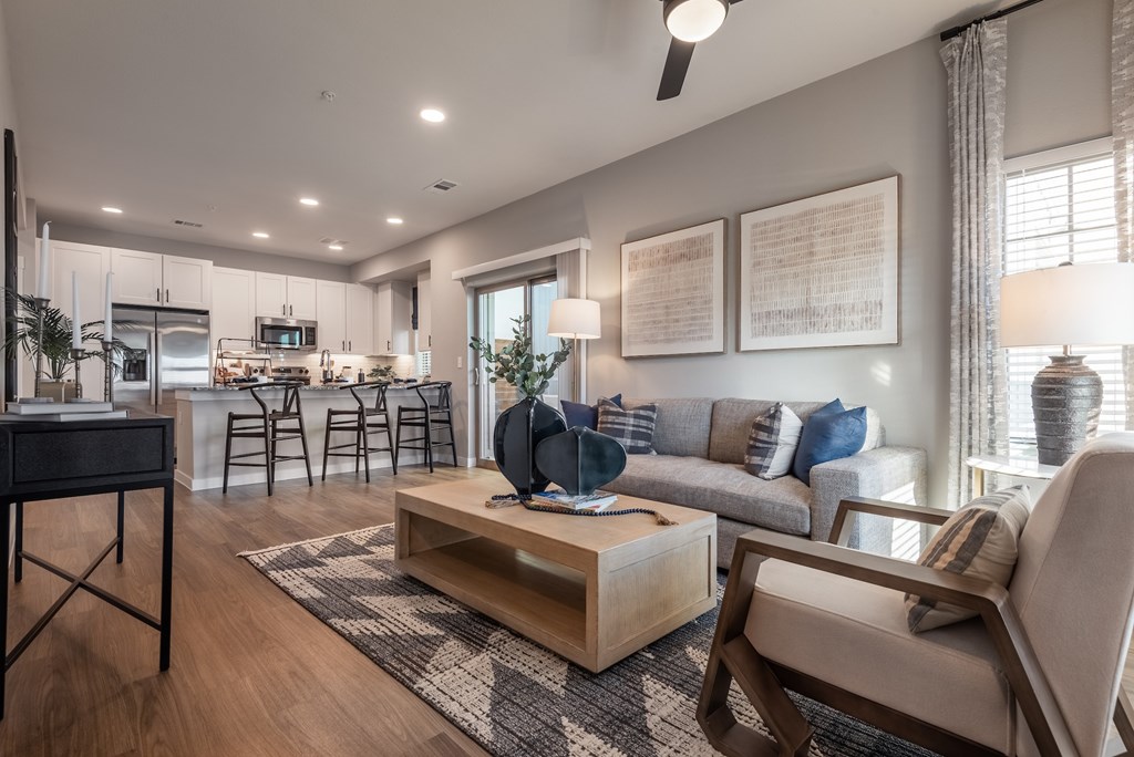 A modern living room with a wooden floor and furniture.