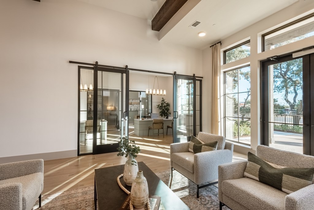 A modern living room with a glass door and a coffee table.