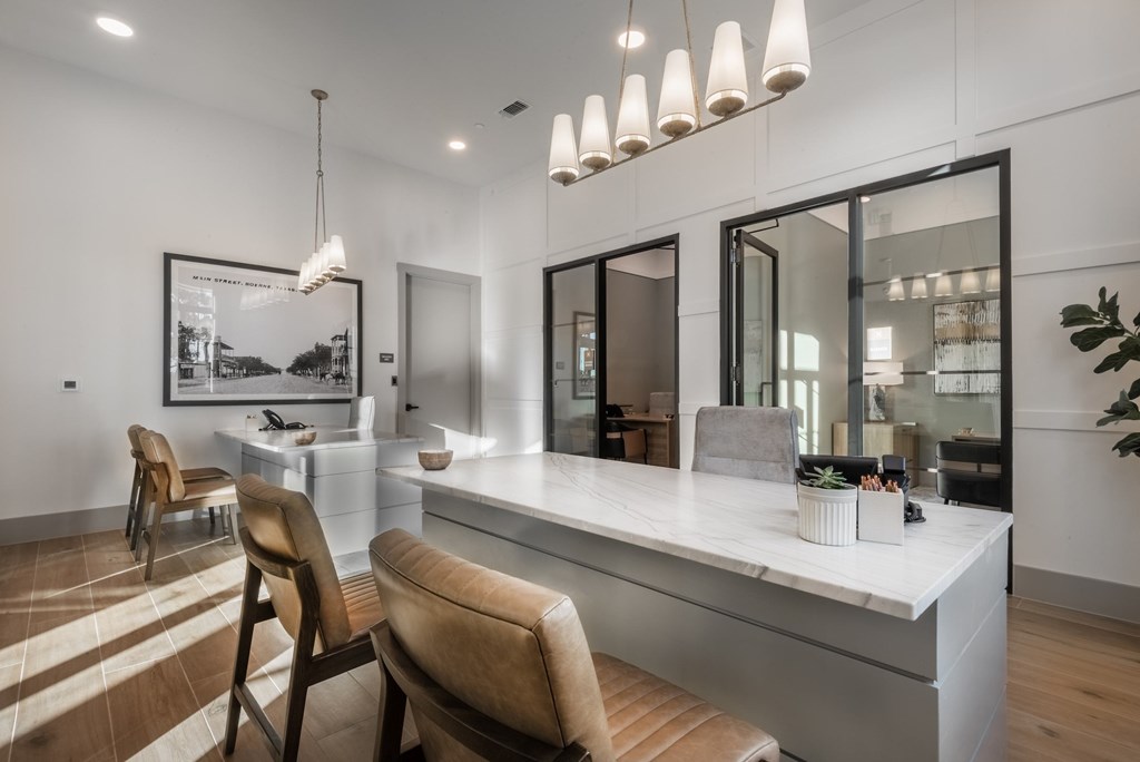 A modern bathroom with a large mirror and a vanity.