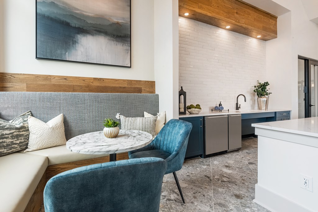 a living room with a couch and chairs and a table