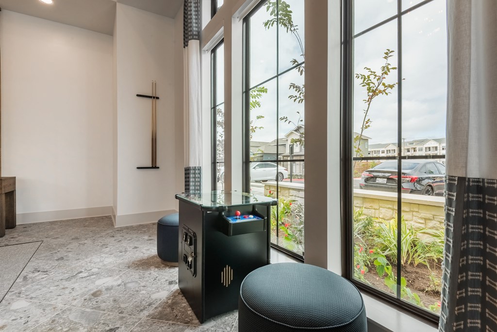 a church lobby with large windows and a cross on the wall