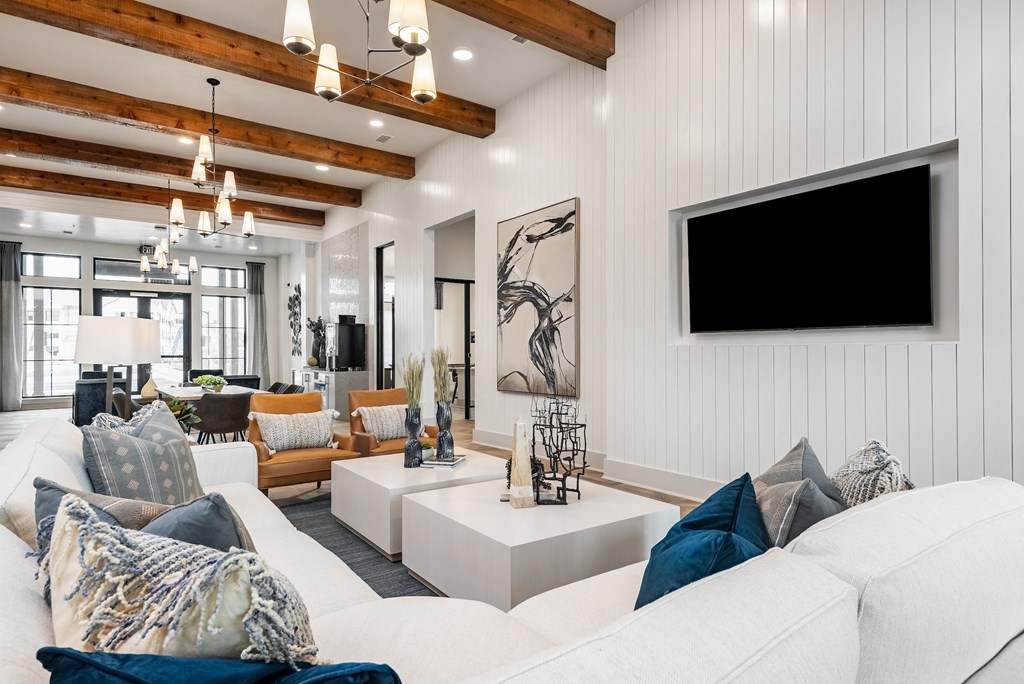 a living room with a white couch and a tv