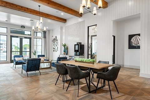 a dining room with a wooden table and chairs