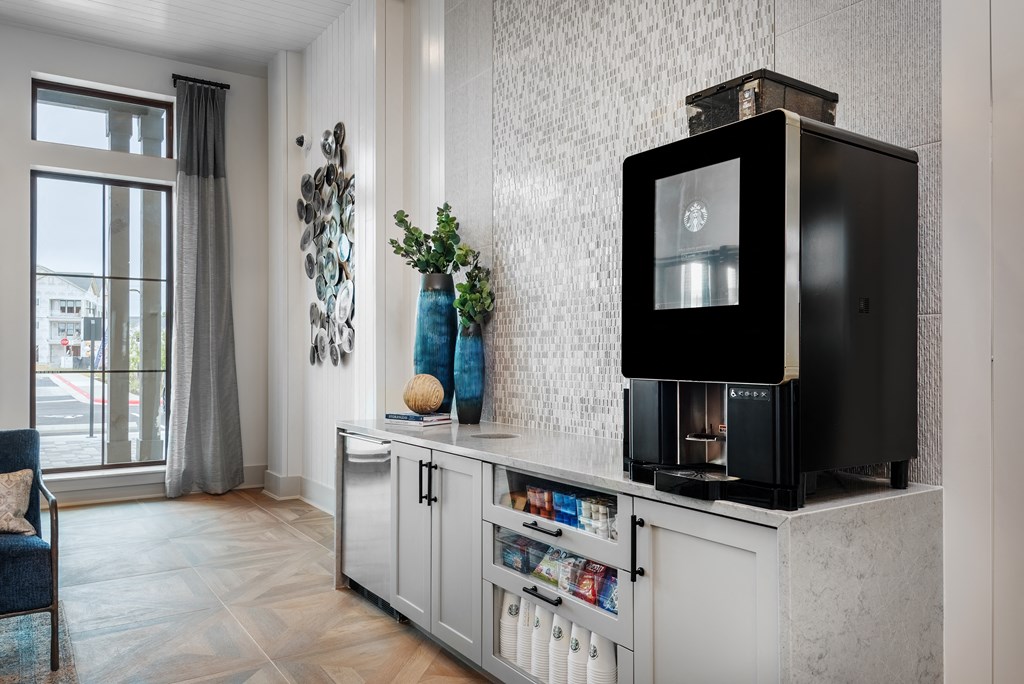 a living room with a television on a counter and a window