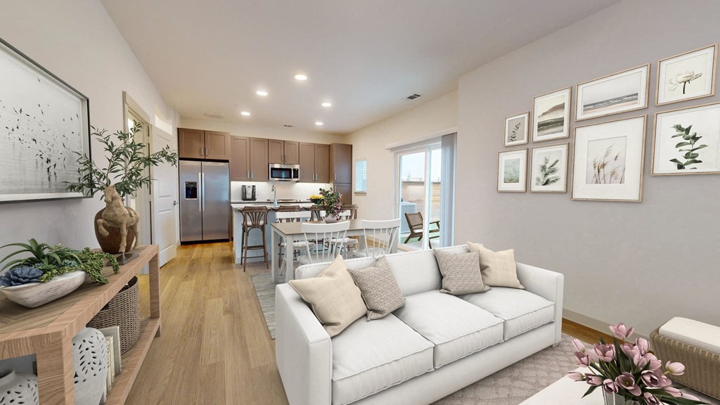 a living room with a couch and a table in a kitchen
