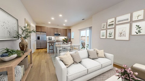 a living room with a couch and a table in a kitchen