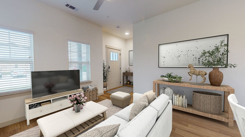 a living room with a white couch and a television
