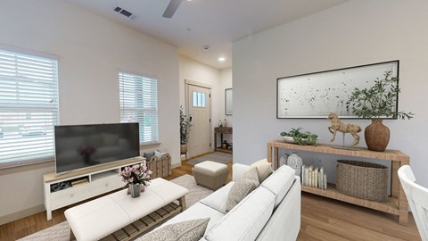 a living room with a white couch and a television