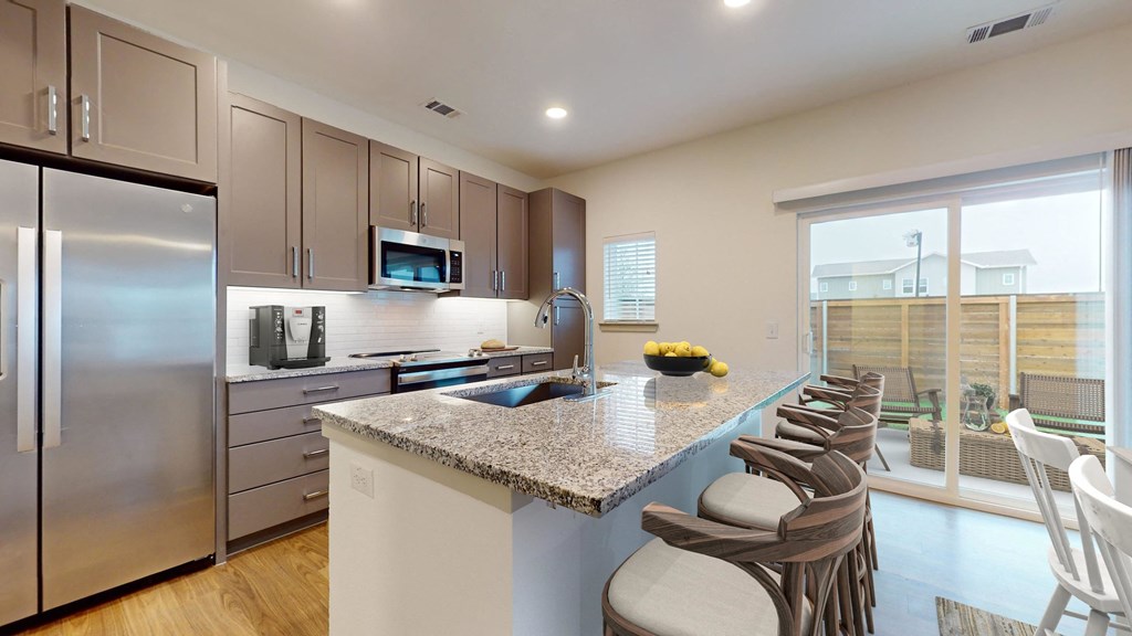 a kitchen with stainless steel appliances and a granite counter top