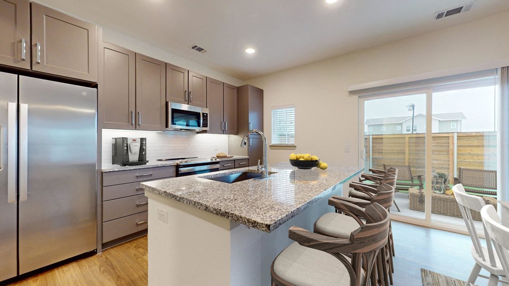 a kitchen with stainless steel appliances and a granite counter top