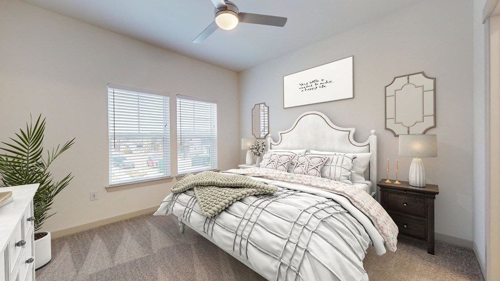 a bedroom with a bed and a ceiling fan