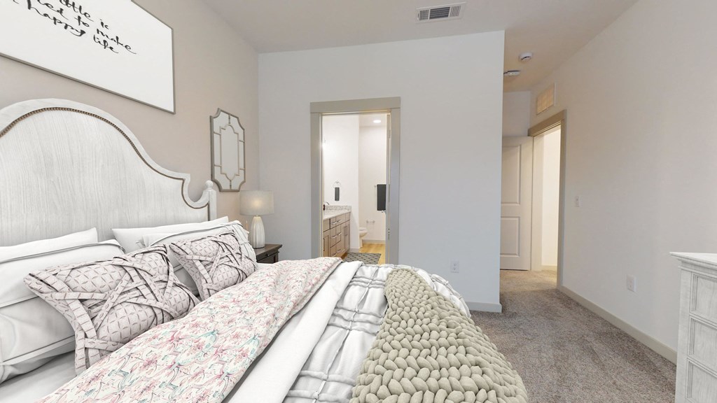 a bedroom with a large bed and a bathroom with a closet