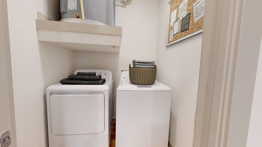 a small laundry room with two washes and a dryer