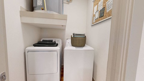 a small laundry room with two washes and a dryer