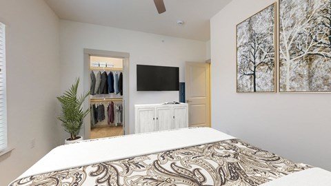 a bedroom with a bed and a tv in the corner