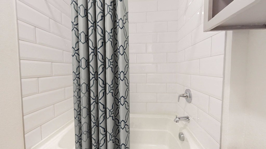 a bathroom with a shower and a shower curtain