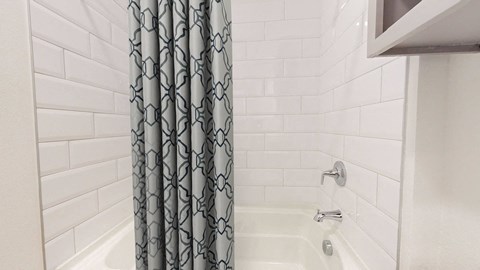 a bathroom with a shower and a shower curtain