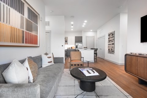A living room with a grey couch and a coffee table.