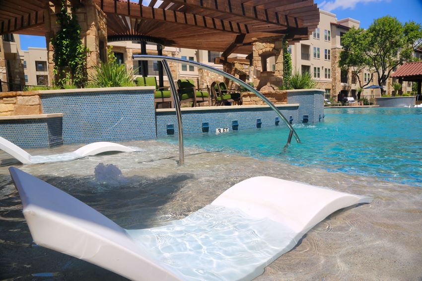 a pool with a hot tub and a lazy river