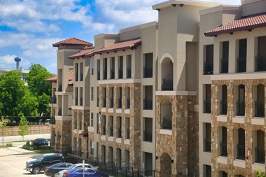 a large building with a parking lot in front of it