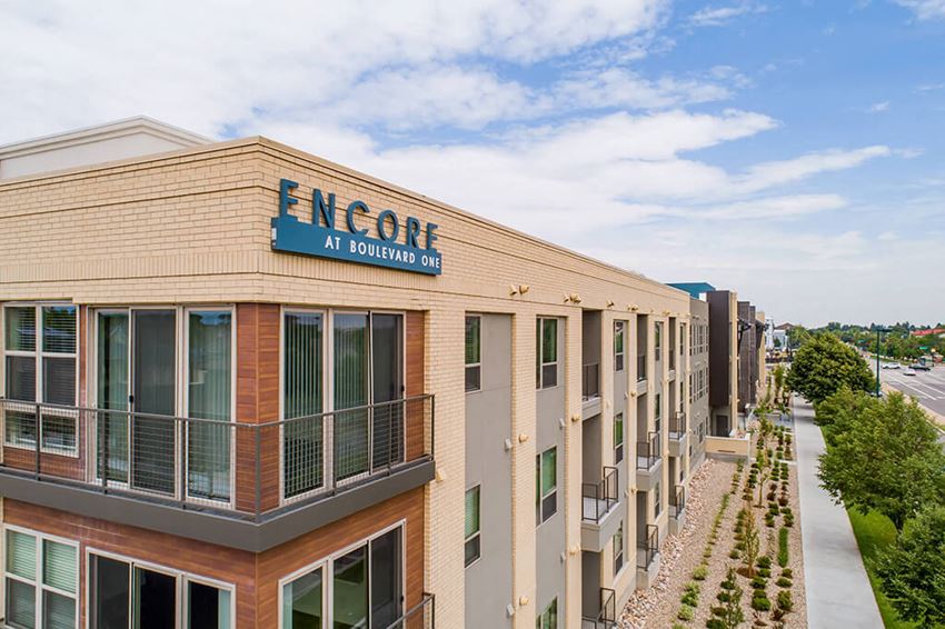 Elegant wood and white brick exterior Elegant wood and white brick exterior at Encore Boulevard One Apartments, 7108 E Lowry Boulevard, CO