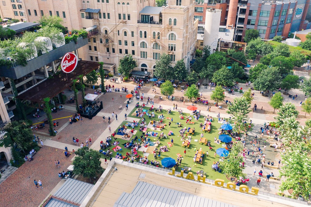 A large group of people are gathered in a park.