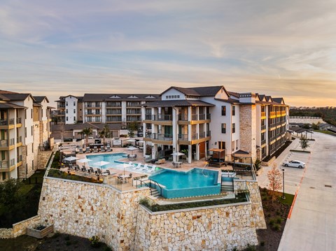 an aerial view of an apartment building with a swimming pool