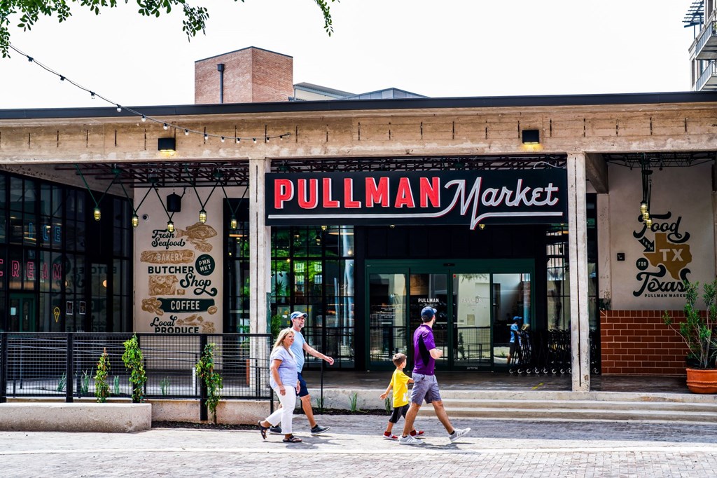 people walking in front of the market on a city street