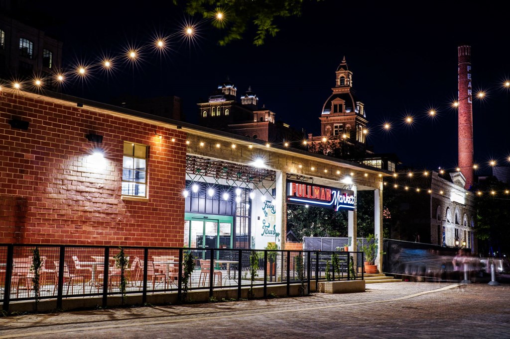 the building in which the hotel is located is lit up at night