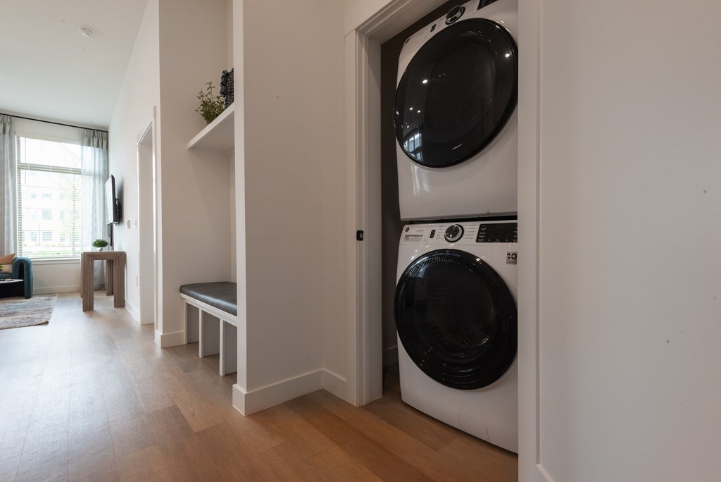 A washing machine is built into a wall in a laundry room.