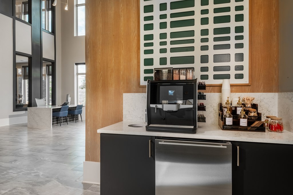 A modern kitchen with a black fridge and a wooden wall.