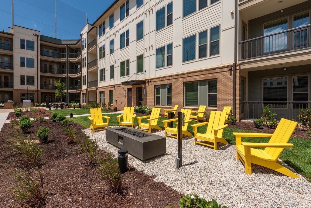 Yellow chairs are arranged in front of a building.