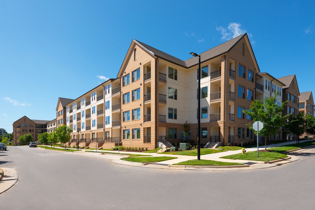 A large apartment building with a clear blue sky above it.