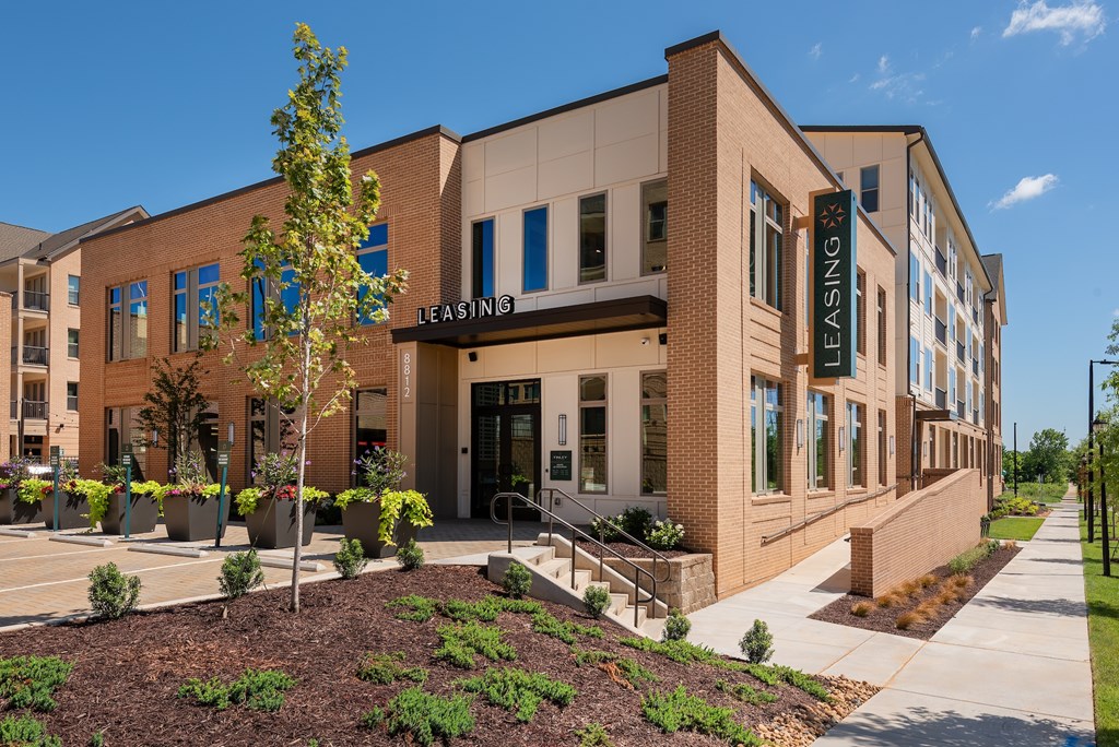 A building with a leasing sign on the front.
